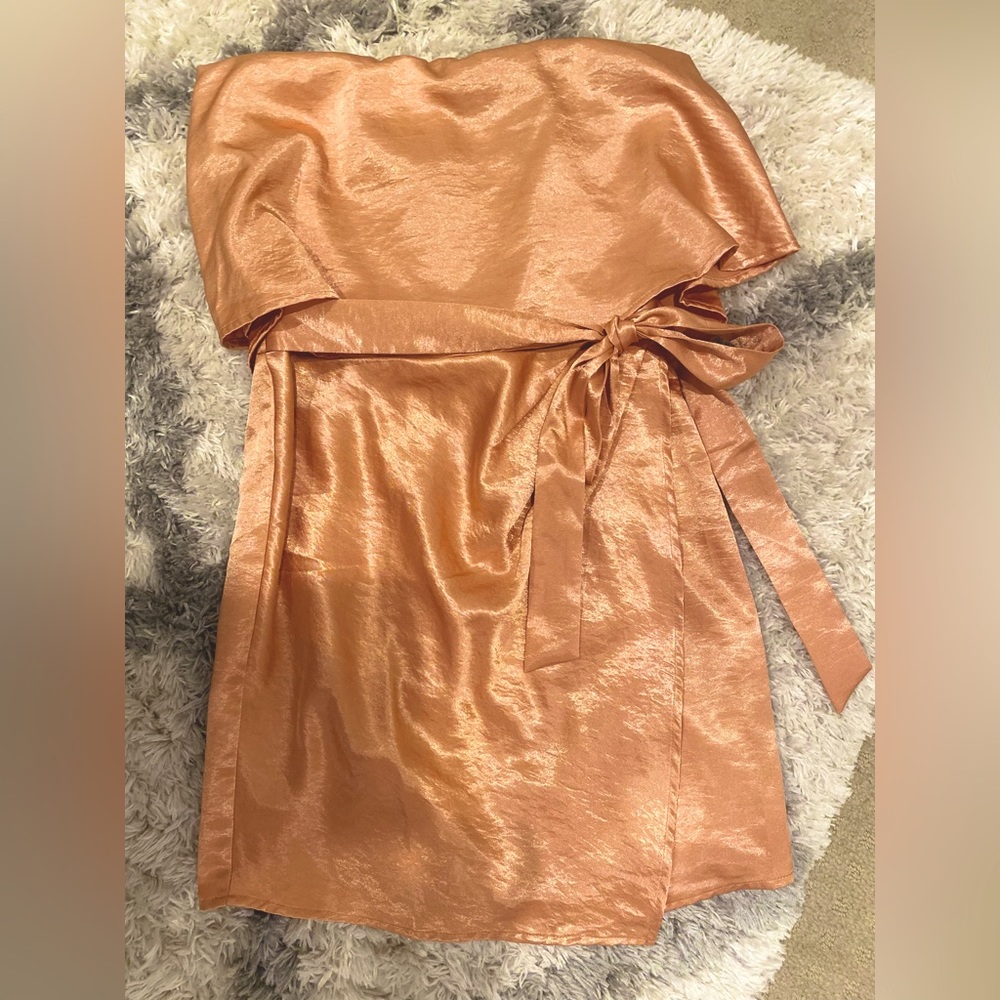 Copper/orange silky strapless mini dress with asymmetric hem and front tie